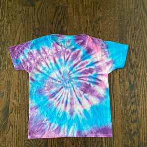 May include: A tie-dye t-shirt with a blue, purple and pink swirl pattern.