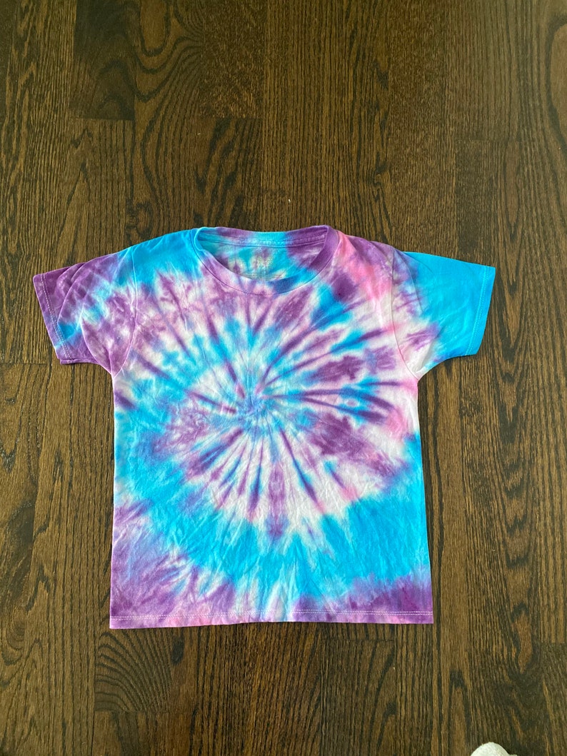 May include: A tie-dye t-shirt with a blue, purple and pink swirl pattern.