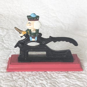 Vintage Cast Iron Nut Cracker with Soldier on Red Wood Base