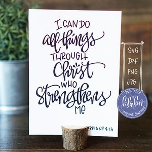 May include: A white card with black calligraphy that reads "I can do all things through Christ who strengthens me" and the scripture reference "Philippians 4:13".