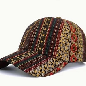 May include: A baseball cap with a patterned design. The cap features a brown base with vertical stripes in red, green, and yellow. The brim is curved and the cap has a button on top.
