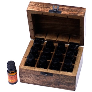 May include: A wooden box with a hinged lid, designed to store essential oils. The box contains twelve small bottles with black caps. A single bottle of rosemary essential oil sits beside the box. The background is white.