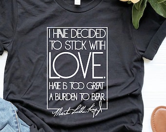 May include: Black t-shirt with a white graphic that says "I have decided to stick with love. Hate is too great a burden to bear." and a signature that says "Martin Luther King Jr."