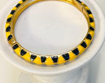 Vintage gold tone black and yellow enamel hinged bangle bracelet