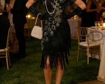 May include: A black flapper dress with fringe and beaded peacock feather design. The dress has a V-neck and is accessorized with a pearl necklace, gloves, and a beaded purse. The shoes are black with gold accents. The image has the text "Retro 1920s Style".