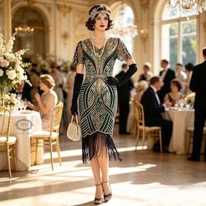 May include: A knee-length emerald green dress featuring intricate gold sequin geometric patterns, short scalloped sleeves, and a black fringe hem. The outfit includes long black gloves, a beaded headband, and a small white beaded handbag.