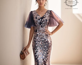 May include: A woman wearing a sequined, navy blue and gold dress with sheer, black sleeves. The dress has a V-neckline and a fitted silhouette. The woman is holding a small, brown clutch purse. The text "Retro 1920s Style" is visible in the upper right corner of the image. The text "Vintage Dress - Headband" is visible below the "Retro 1920s Style" text.