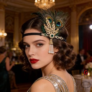 May include: A vintage-style headband with a black velvet band and a decorative centerpiece. The centerpiece features green and gold embellishments, peacock feathers, and dangling faux pearls. The headband is worn by a person with red lipstick and a sequined dress.