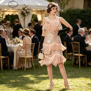May include: A woman in a pink sequined flapper dress with fringe, black gloves, and a pearl-handled purse. She is wearing a pearl necklace and a jeweled headband. The scene is set outdoors at a garden party.