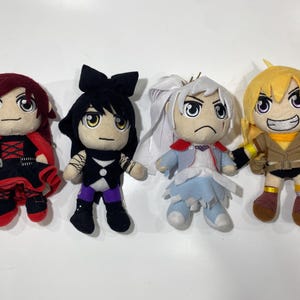 May include: Four plush dolls representing characters with distinct features. The first has dark red hair and a black and red outfit. The second has black hair with a bow and a black and purple outfit. The third has white hair and a light blue outfit. The fourth has yellow hair and a brown outfit.