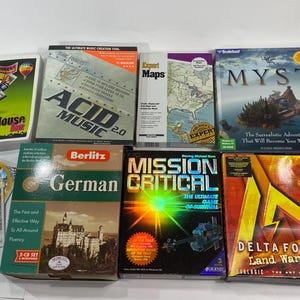 May include: A collection of vintage computer software and educational CDs. Titles include "Acid Music 2.0", "Myst", "Dizone 2", "Delta Force", and a Berlitz German language learning set. The items are in their original packaging.