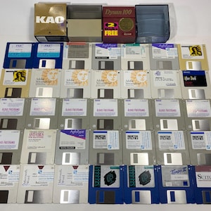May include: A collection of 3.5 inch floppy disks, including software titles such as Aldus Freehand, Microsoft Word, Adobe Streamline, After Dark, and AgfaType. The disks are arranged in rows on a white surface. Some of the disks are in clear plastic cases, while others are in paper sleeves.