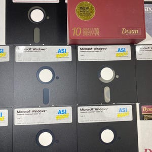 May include: A box of 10 Dysan 100 MO2HD formatted diskettes. The box is red with gold lettering. The diskettes are black with white labels that say "Microsoft Windows" and "ASI 5000".