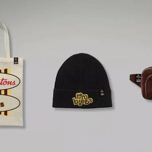 May include: A cream-coloured canvas tote bag with Tim Hortons and tim biebs logos, a black knit beanie with a yellow tim biebs patch, and a brown corduroy bum bag featuring a tim biebs logo. Each item includes a small black brand tag.