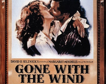 May include: A vintage movie poster for the film "Gone With The Wind" featuring Clark Gable and Vivien Leigh in a romantic embrace. The poster is in a brown frame with a floral design. The text on the poster reads "Gone With The Wind" in large, bold letters. The poster also includes the names of the actors, the director, and the production company.