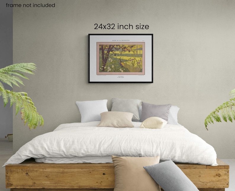 May include: A framed print of a vintage illustration depicting a landscape with a river, trees, and a bird. The print is 24x32 inches and is displayed on a wall above a bed with white linens and pillows.
