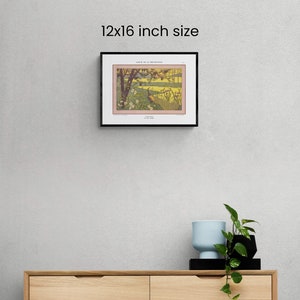 May include: A black framed print of a vintage illustration of a bird in a landscape. The print is 12x16 inches and the title of the illustration is "Ailes de la Dromader." The print is hanging on a light gray wall above a wooden dresser.