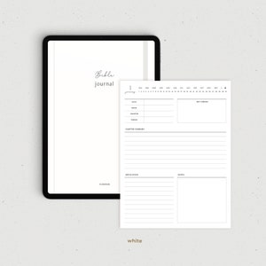 May include: A white digital planner with a black border and the text "Bible Journal" at the top. The planner has a calendar for the year, a section for daily entries, and a section for notes.