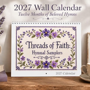 May include: A 2027 wall calendar titled 2027 Wall Calendar Twelve Months of Beloved Hymns. The cover features a cross-stitch design with purple flowers and green vines, centered with the text Threads of Faith: Hymnal Samplers.