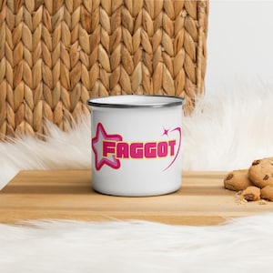 May include: White enamel camping mug with a pink star and the word "FAGGOT" in yellow letters.