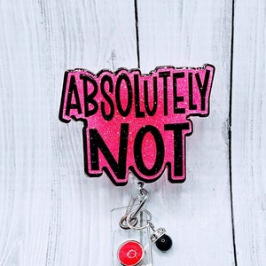 May include: Pink glitter badge holder with a black "ABSOLUTELY NOT" text. The holder has a retractable badge reel with a red button and a black bead.