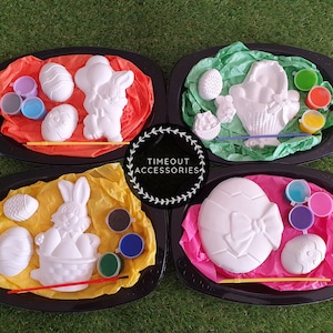 May include: Four ceramic Easter-themed paint-your-own kits. Each kit includes a bunny, egg, or basket, along with a small paintbrush and four pots of paint.
