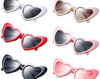 May include: Set of six heart-shaped sunglasses in various colors, including black, white, red, pink, and brown. The sunglasses have a retro style and are perfect for a fun and fashionable look.