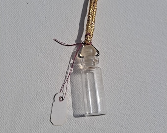 Glass vial with stopper pendant on gold color cord