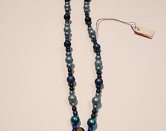 Black-haired dark skin Mermaid Clay Pendant on earth-tone dull blue ball beaded knecklace