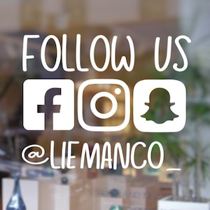 May include: White sign on a glass door with the text "FOLLOW US" and social media icons for Facebook, Instagram, and Snapchat. The text "@LIEMANCO_" is below the icons.