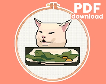 May include: Cross-stitch pattern featuring the Distracted Cat meme, with a pixelated image of the cat and a plate of food. The design is set within an embroidery hoop, with the words "PDF download" in the upper right corner.