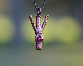 Handmade adjustable runic necklace made from recycled copper plated dogwood wood adorned with a garnet cabochon
