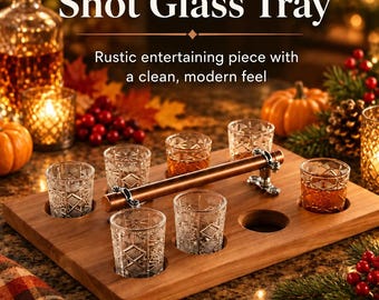 May include: A rectangular cedar wood shot glass tray featuring a horizontal copper pipe handle with silver-toned metal fittings. The tray includes six circular cutouts, five of which hold clear glass shot glasses with a geometric pattern.