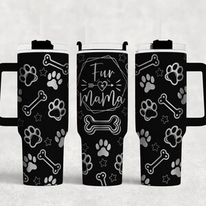 May include: A black stainless steel tumbler with a silver paw print and bone design. The tumbler has a lid and a handle. The text "Fur Mama" is printed on the front of the tumbler.