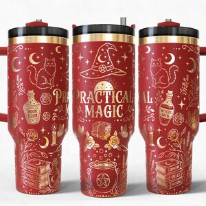 May include: A red insulated tumbler with a handle and a black lid, featuring gold-colored illustrations of a cat, a witch hat, a cauldron, books, and bottles labeled Moon Elixir and Witch's Brew, with the text Practical Magic printed in gold.