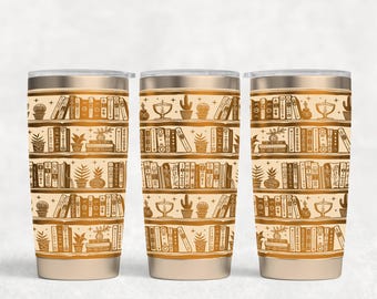 May include: Three stainless steel tumblers with a gold pattern of books on shelves. The pattern is repeated on each tumbler.