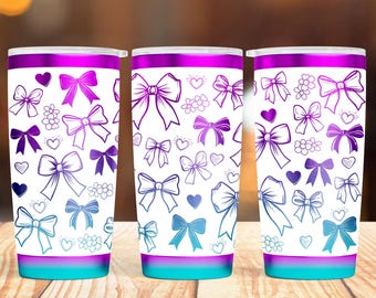 May include: Three stainless steel tumblers with a white background and a pattern of blue and purple bows, hearts, and flowers. The tumblers have a gradient design with a purple top and a turquoise bottom.