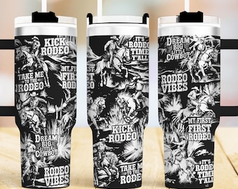 May include: Three black and white stainless steel tumblers with a rodeo theme. The tumblers feature cowboys riding horses, the words "Kick Rodeo", "Take Me To The Rodeo", "My First Rodeo", "It's Rodeo Time Y'all", "Dream Big Little Cowboy", and "Rodeo Vibes".