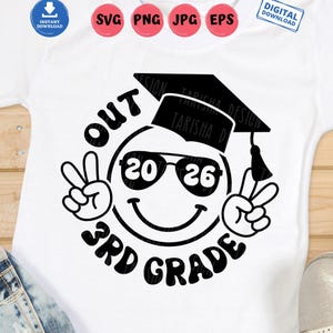 May include: White t-shirt with a black graphic. The graphic features a smiley face wearing sunglasses and a graduation cap, with the text "OUT 3RD GRADE 2026" and peace signs.
