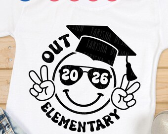 May include: White t-shirt with a black graphic. The graphic features a smiley face wearing sunglasses and a graduation cap, with the text "OUT ELEMENTARY 2026". The design includes peace signs on either side of the face.