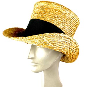 May include: A straw hat with a black band around the crown. The hat is tall and has a wide brim.