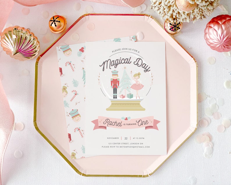 May include: A pink and white invitation with a snow globe illustration featuring a nutcracker and a ballerina. The text reads "Please join us for a Magical Day Rachel is turning One November 22 at 12:30pm 123 Center Street, London ON Please RSVP to metomspon@hotmail.com"