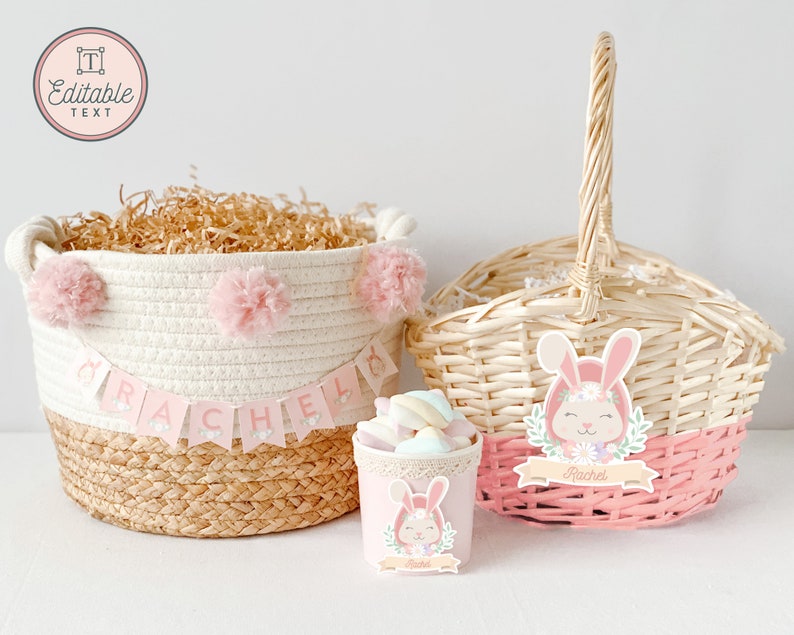 May include: Two Easter baskets with pink and white bunny decorations. One basket is made of woven wicker and the other is a white rope basket with pink pom-poms. Both baskets have a pink banner with the name "Rachel" on them.