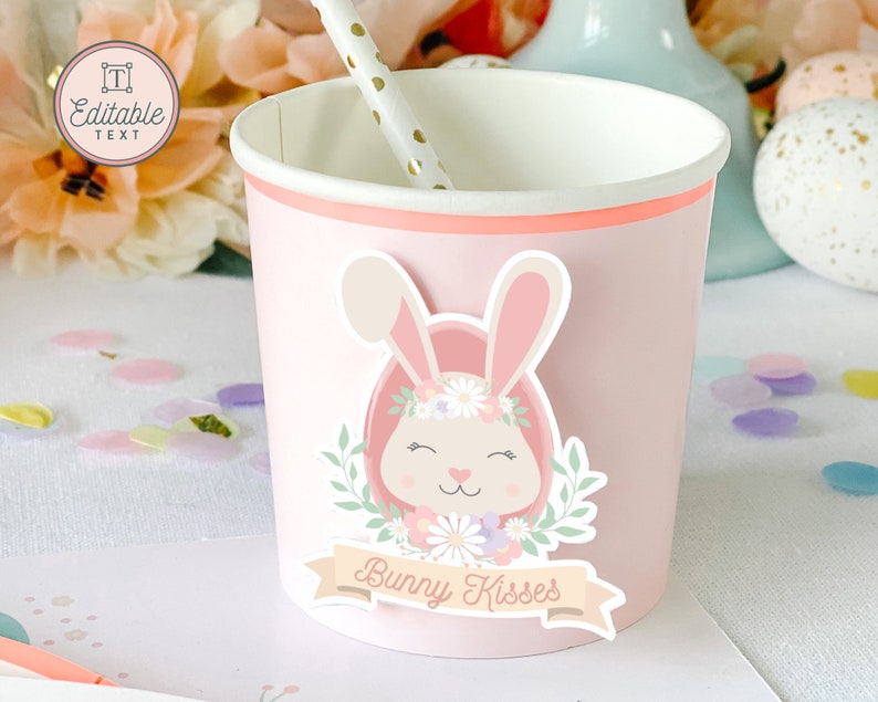 May include: Pink paper cup with a bunny sticker. The sticker features a pink bunny with a flower crown and the text "Bunny Kisses".