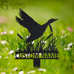 May include: Black metal garden stake featuring a silhouette of a goose flying over tall grass with the text "CUSTOM NAME" on a metal plaque.