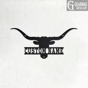 May include: Black metal silhouette of a longhorn steer head with large horns and a nameplate that reads "CUSTOM NAME".