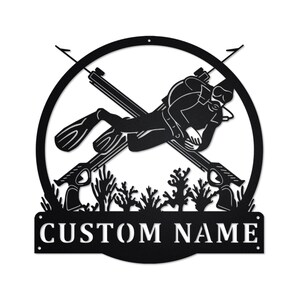 May include: Black metal wall art featuring a scuba diver with spearguns, coral, and the text "CUSTOM NAME".