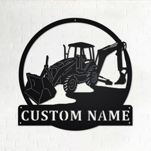 May include: Black metal silhouette of a backhoe excavator in a circle with the text "CUSTOM NAME" below.