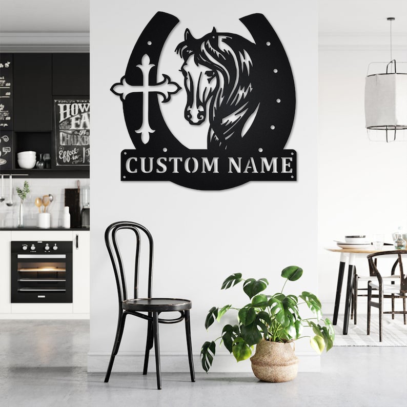May include: Black metal wall decor featuring a horseshoe with a cross and a horse head silhouette. The text "CUSTOM NAME" is displayed below the horseshoe.