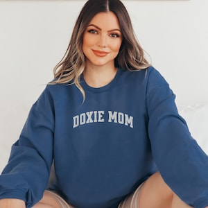 May include: A navy blue sweatshirt with the text "DOXIE MOM" in white lettering.